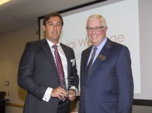 Luigi Wewege being congratulated by Charles E. Hoffman the Dean of the College of Business Administration at UMSL in St. Louis, Missouri.